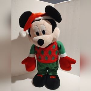 Mickey Mousestands spreading Christmas cheer and greets your family + guests.